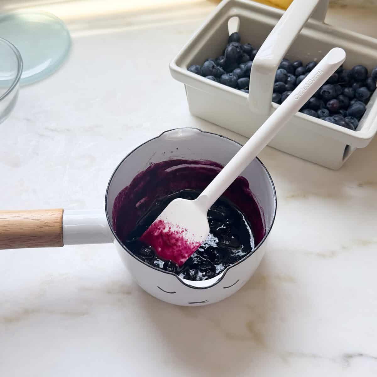 Blueberry compote in small pot.