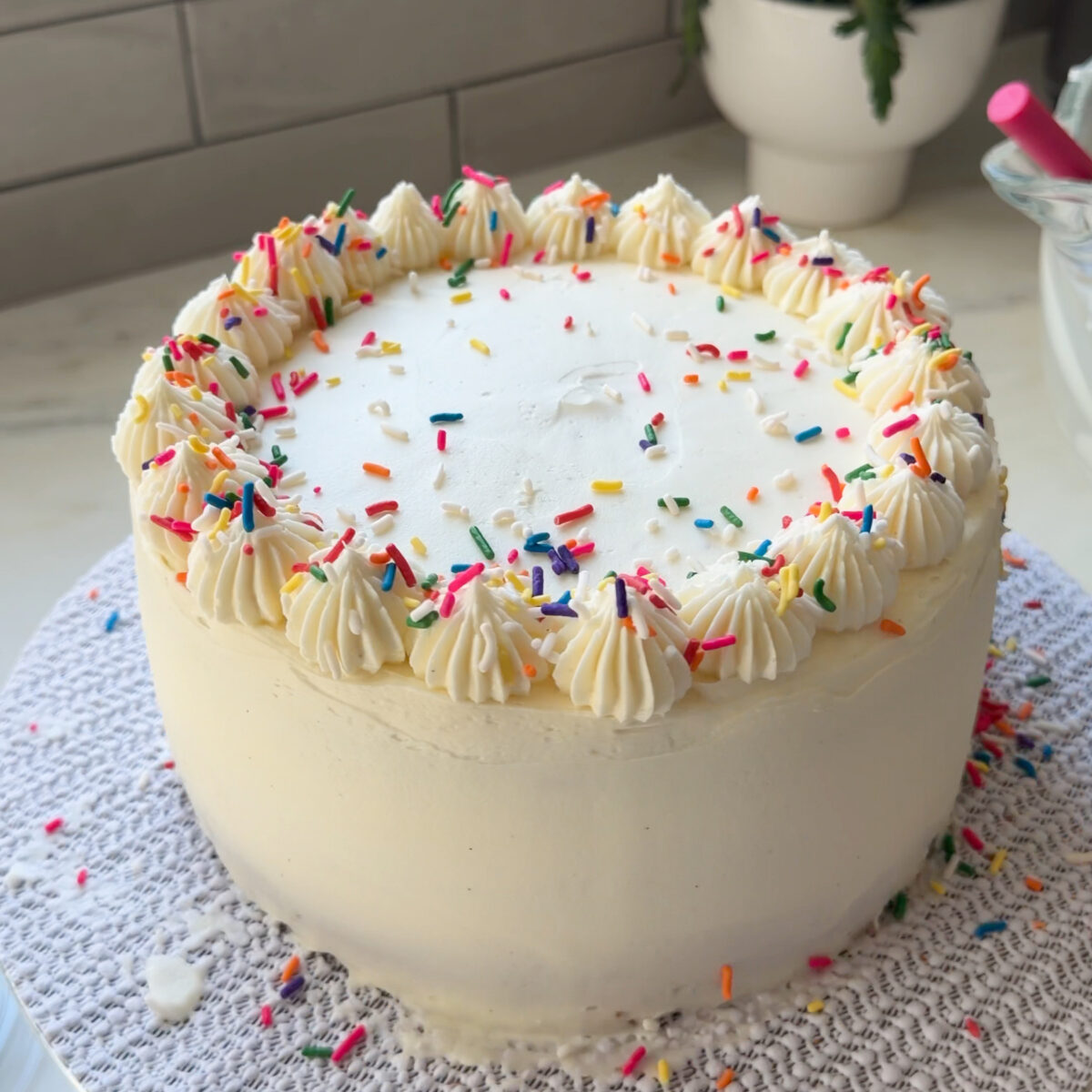 Decorating frosted funfetti cake.