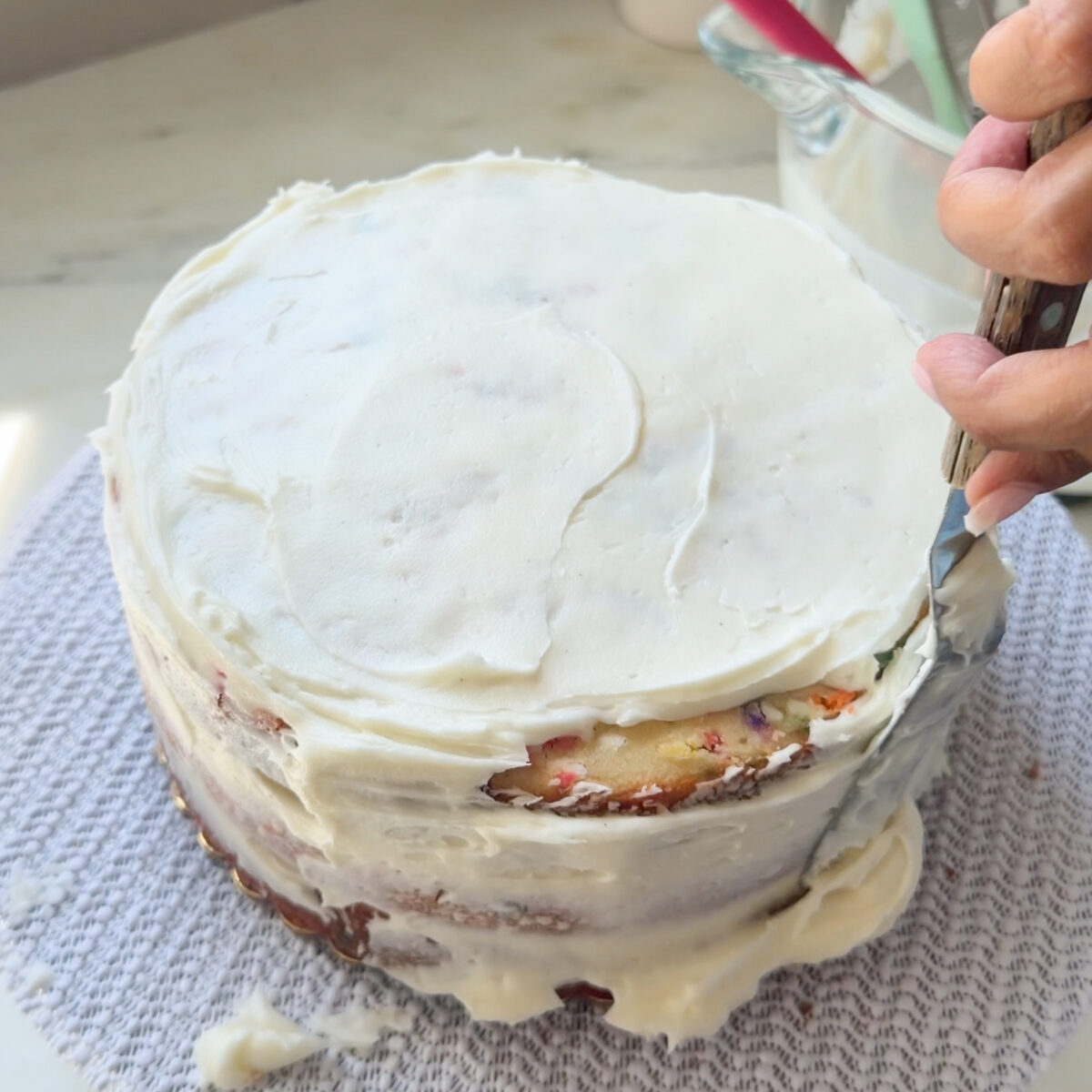 Frosting funfetti cake.