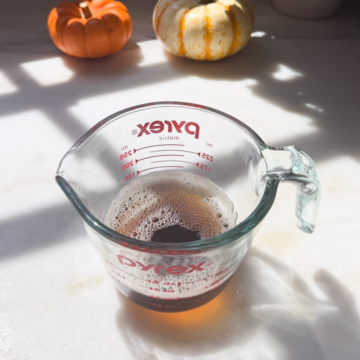 Brown butter in measuring cup.