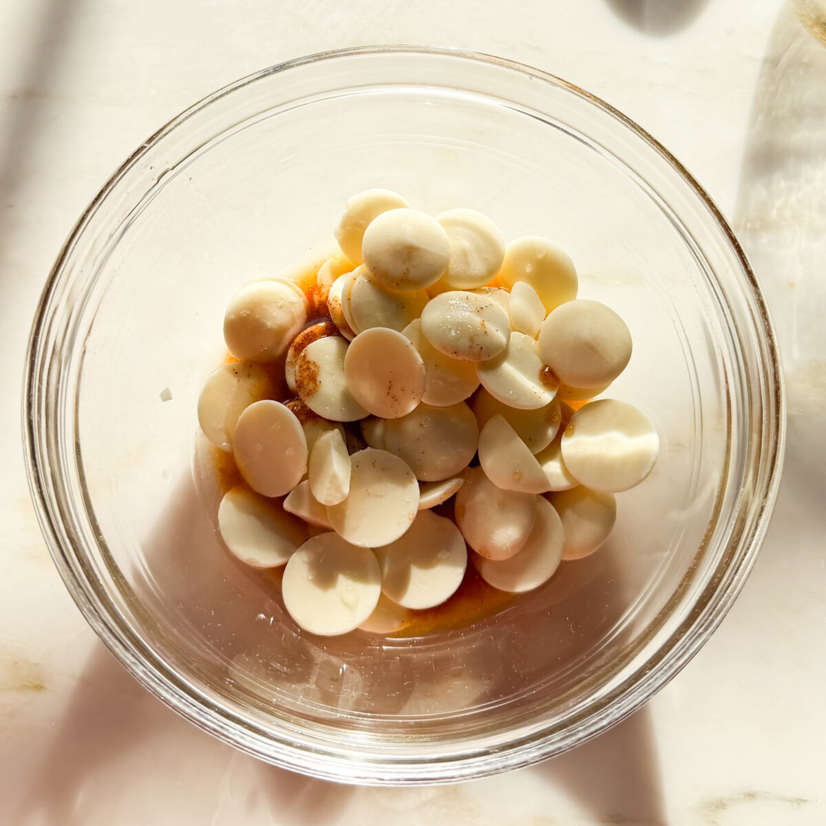 White chocolate, apple cinnamon syrup, and lemon juice in small bowl.