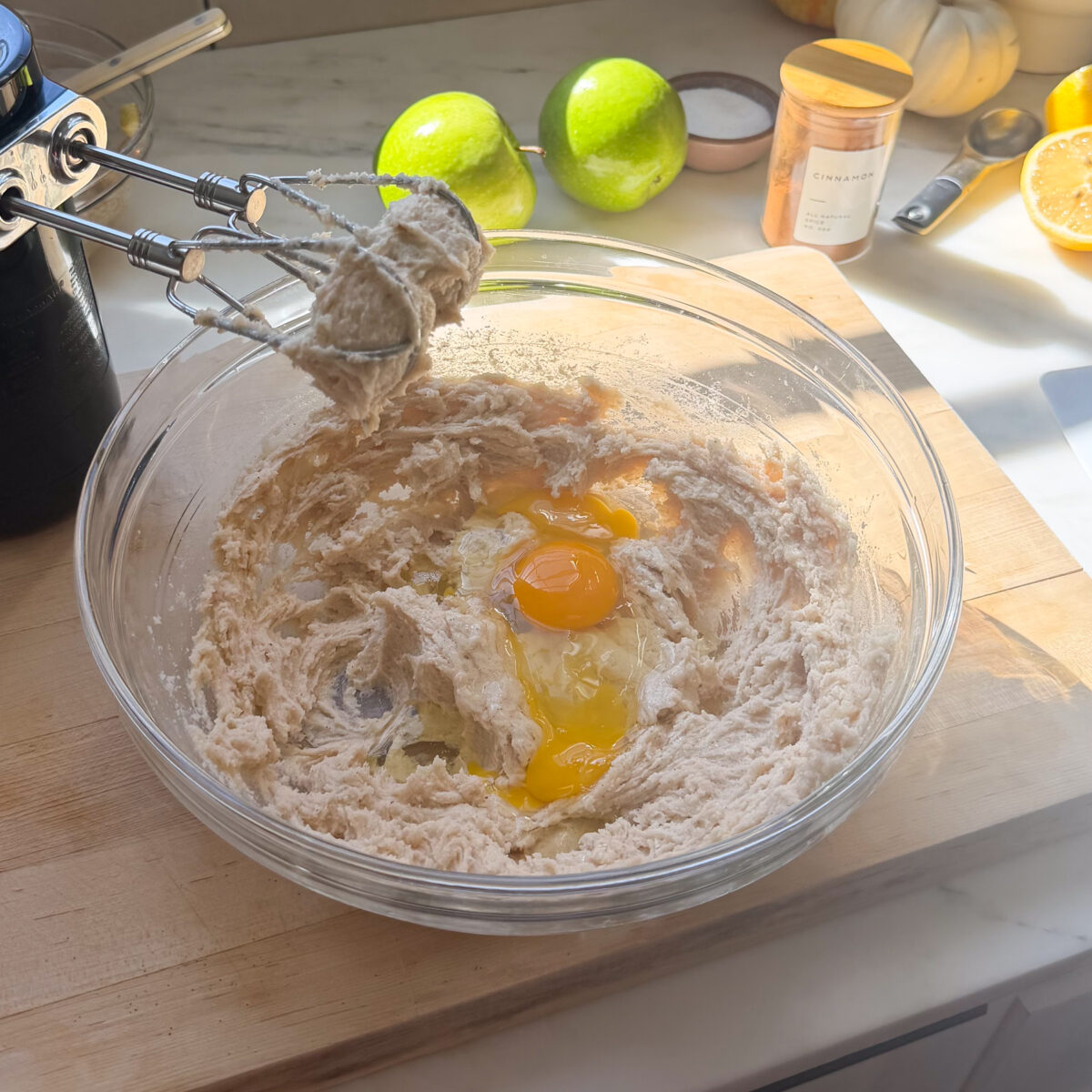 Butter mixture and eggs in a large bowl.