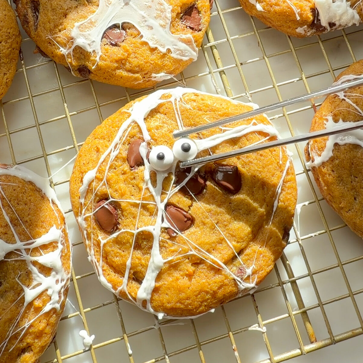 Decorating cookies on cooling rack.